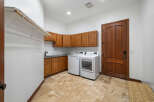 This stunning laundry room boasts ample storage with custom wood cabinets and a convenient built-in hanging rod.