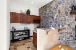 This stunning home boasts a built-in bar with granite countertops and custom cabinetry, perfect for entertaining guests.