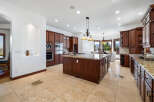 This stunning kitchen boasts beautiful dark wood cabinetry, granite countertops, and high-end stainless steel appliances.