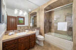 This luxurious bathroom boasts a spacious shower with glass enclosure and a modern vanity with ample storage.