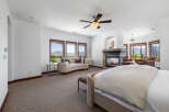 Luxurious master bedroom with stunning mountain views and a cozy fireplace.