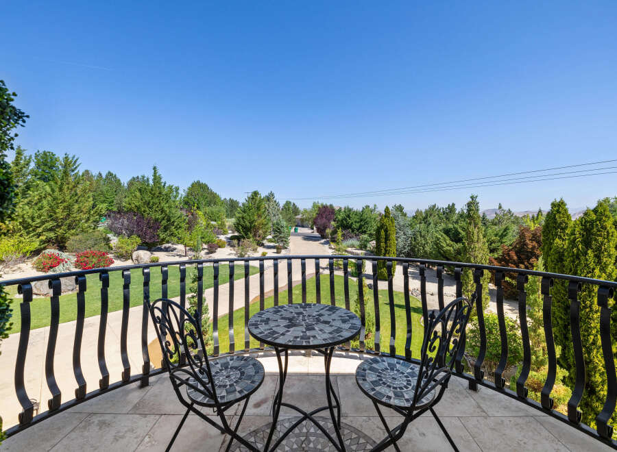 This luxurious property boasts a stunning balcony overlooking a meticulously landscaped garden.