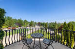 This luxurious property boasts a stunning balcony overlooking a meticulously landscaped garden.