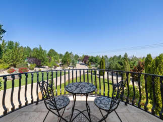 This luxurious property boasts a stunning balcony overlooking a meticulously landscaped garden.