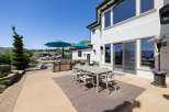 This stunning property boasts a spacious outdoor patio perfect for entertaining, complete with a built-in BBQ, comfortable seating area, and stylish dining set.