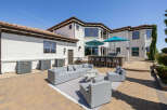 This stunning property boasts a spacious outdoor patio perfect for entertaining, complete with a built-in bar and comfortable seating areas.
