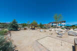 This stunning property boasts a spacious backyard perfect for outdoor entertainment, featuring a sand volleyball court and horseshoe pit.