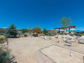This stunning property boasts a spacious backyard perfect for outdoor entertainment, featuring a sand volleyball court and horseshoe pit.