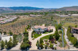 This stunning property boasts a large, luxurious home with a beautiful landscape and a private driveway.