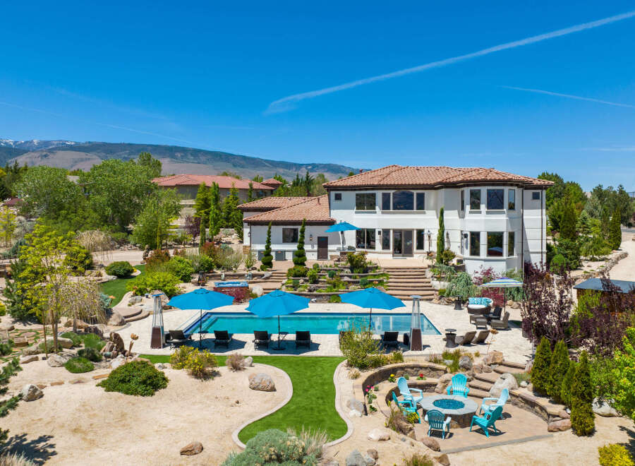 This stunning property boasts a luxurious outdoor oasis, complete with a sparkling pool, spacious patio, and fire pit.