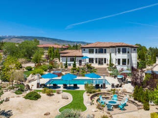 This stunning property boasts a luxurious outdoor oasis, complete with a sparkling pool, spacious patio, and fire pit.