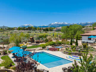 Luxury estate boasting a stunning pool and spa, nestled in a picturesque mountain setting.