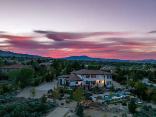 Luxury estate boasting a stunning sunset view, expansive backyard oasis with a pool and fire pit, and a spacious interior perfect for entertaining.