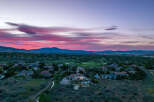 Luxury estate nestled in a serene landscape, offering breathtaking sunset views.