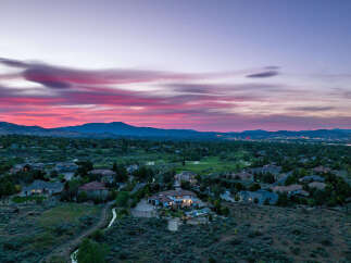 Luxury estate nestled in a serene landscape, offering breathtaking sunset views.