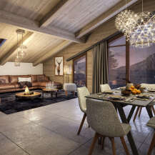 This stunning chalet boasts a spacious open-plan living area with a cozy fireplace, perfect for relaxing after a day on the slopes.