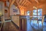 This stunning chalet boasts a spacious open-plan living area with a modern kitchen and dining area.