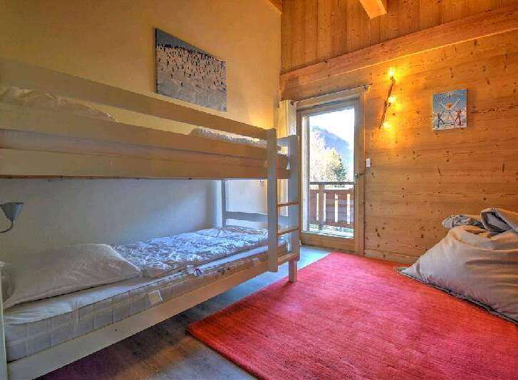 Cozy chalet bedroom with a bunk bed, perfect for families or groups.