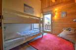 Cozy chalet bedroom with a bunk bed, perfect for families or groups.