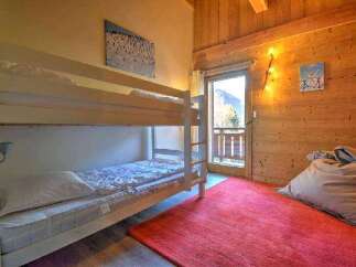 Cozy chalet bedroom with a bunk bed, perfect for families or groups.
