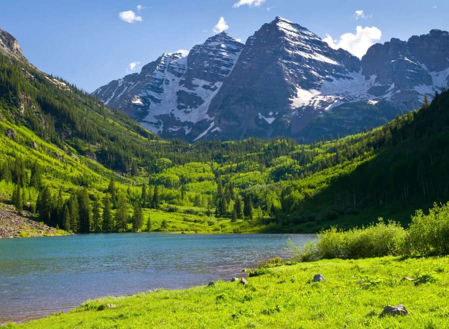 Nestled in the heart of Colorado's majestic mountains, this serene lakefront property offers breathtaking views of snow-capped peaks and lush greenery.