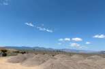 Discover tranquility in this expansive desert landscape, featuring stunning mountain views and ample space for outdoor adventures.