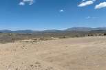 This expansive property boasts breathtaking views of the surrounding mountains and a vast, open landscape perfect for outdoor enthusiasts.