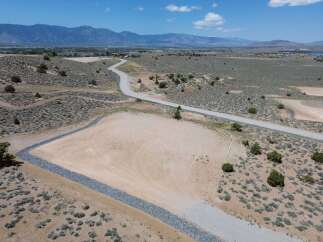 This property boasts stunning mountain views and a spacious, level lot perfect for building your dream home.