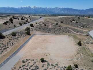 This property boasts a spacious, level lot perfect for building, nestled in a serene desert landscape.