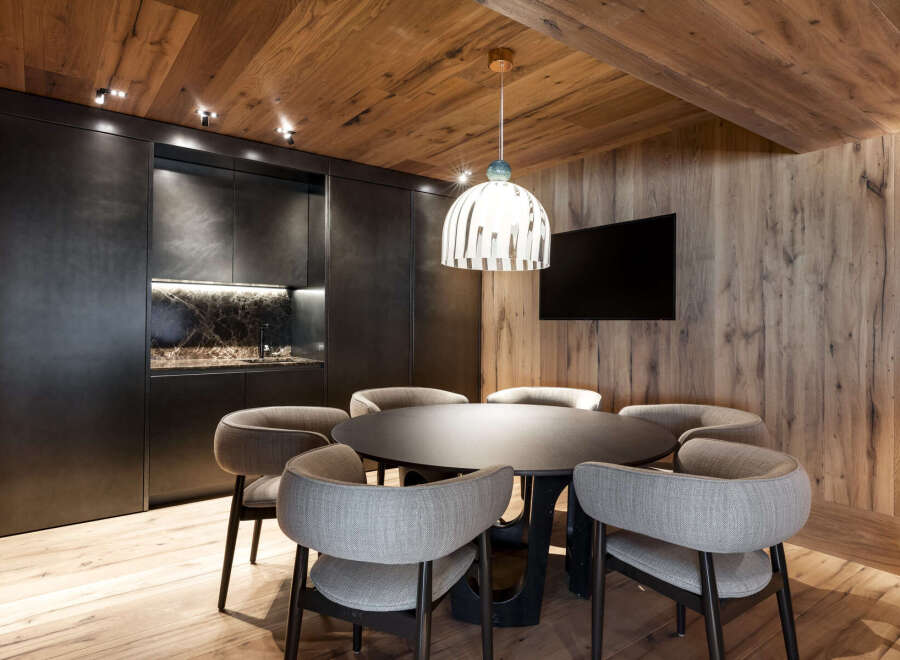 This stunning property boasts a modern kitchen with sleek dark cabinetry and marble countertops, perfect for entertaining guests.