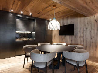 This stunning property boasts a modern kitchen with sleek dark cabinetry and marble countertops, perfect for entertaining guests.