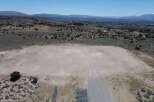 This undeveloped lot boasts a spacious, level building pad, perfect for your dream home.