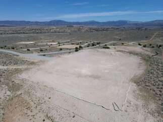 This property boasts a large, flat, and undeveloped area perfect for various uses.