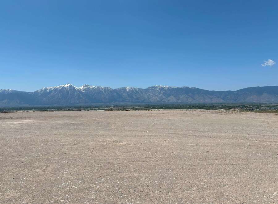 This expansive property boasts breathtaking views of the snow-capped mountains.