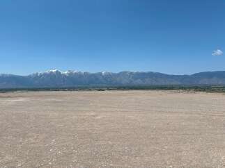 This expansive property boasts breathtaking views of the snow-capped mountains.