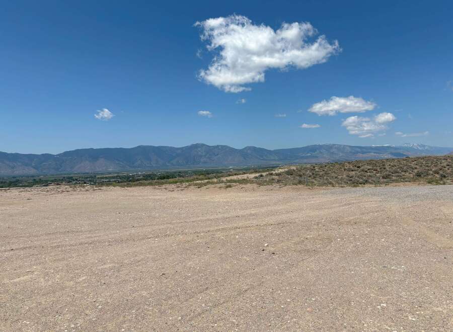 This stunning property boasts breathtaking views of the majestic mountains and a vast expanse of clear blue sky.