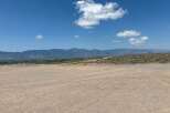 This stunning property boasts breathtaking views of the majestic mountains and a vast expanse of clear blue sky.