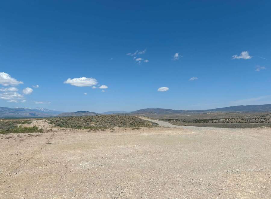 Discover tranquility in this expansive desert landscape, featuring a vast, open terrain perfect for exploration and adventure.