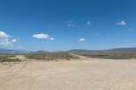 Discover tranquility in this expansive desert landscape, featuring a vast, open terrain perfect for exploration and adventure.
