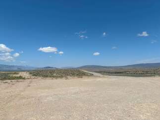 Discover tranquility in this expansive desert landscape, featuring a vast, open terrain perfect for exploration and adventure.