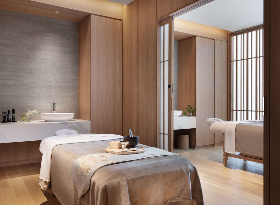 Indulge in tranquility at our luxurious spa, featuring serene private treatment rooms with plush massage tables and modern amenities.