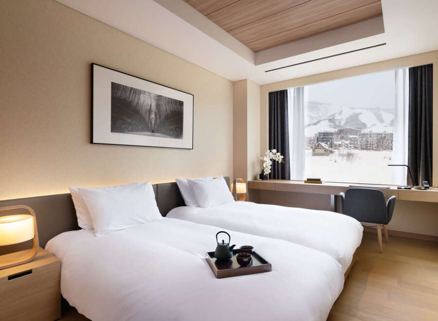 Wake up to breathtaking mountain views from this luxurious hotel room.