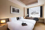 Wake up to breathtaking mountain views from this luxurious hotel room.