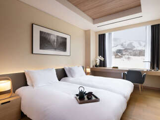 Wake up to breathtaking mountain views from this luxurious hotel room.