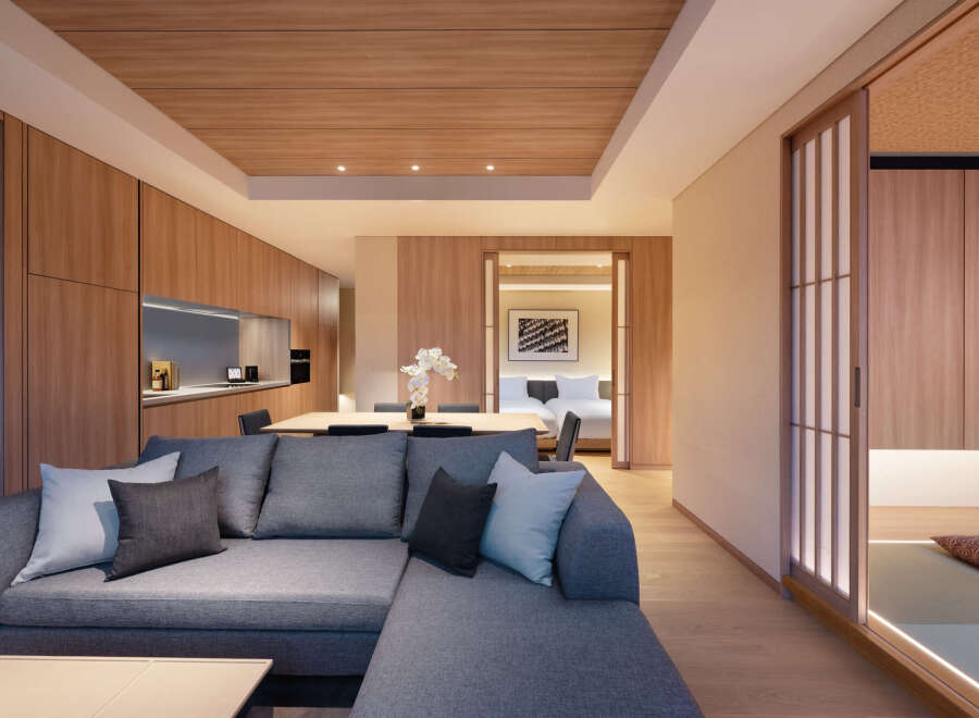 This stunning apartment boasts a spacious living area with a comfortable sectional sofa, perfect for relaxation.