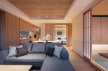 This stunning apartment boasts a spacious living area with a comfortable sectional sofa, perfect for relaxation.