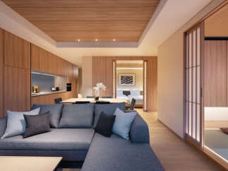 This stunning apartment boasts a spacious living area with a comfortable sectional sofa, perfect for relaxation.