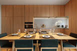 This stunning apartment boasts a modern kitchen with sleek wooden cabinetry and integrated appliances.