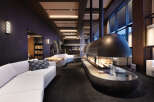 Luxury hotel lobby with a stunning fireplace as the centerpiece.