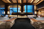 Luxurious lodge with floor-to-ceiling windows offering breathtaking mountain views.